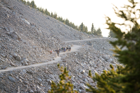 an unidentified group of people hiking to watchman's peak in Crater Lake National PArk to see the sunsetの写真素材