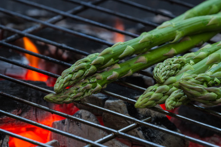 grilled asparagus on an outdoor grill with open flameの写真素材