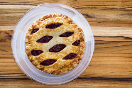 view form above of a fresh baked cherry pie on a wooden table