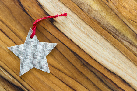 holiday background for the month of december  with a natural wood table and a star labelの写真素材