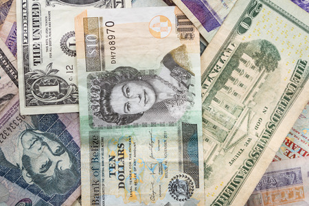 close up of cash bills from different countries around the worldの写真素材