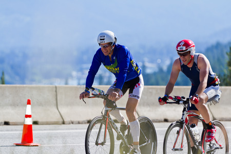 COEUR D ALENE, ID -  JUNE 23: Klaus Wuttig and Devin Wahl,Triathletes on the bike part of the ironman triathlon, June 23 2013 in Coeur d' Alene Idahoのeditorial素材