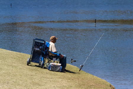 Payson, Arizona - March 23 : unknown male fishing in a like on a sunny afternoon, March 23 2015 in Payson, Arizona.のeditorial素材
