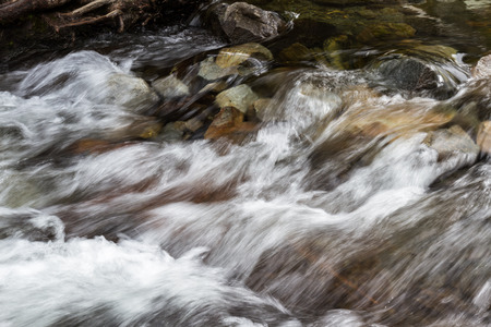 Spring water flowing over rocks in to Lake Tahoe from the California sideの写真素材