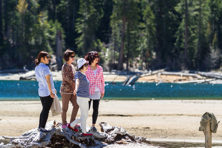 Lake Tahoe, California - April 29 : Asian tourists posing for a picture on the shore of Emerald Bay, April 29 2015 Lake Tahoe, California.のeditorial素材