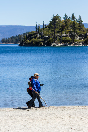 Lake Tahoe, California - April 29 : American tourists walking the shore of Emerald Bay, April 29 2015 Lake Tahoe, California.のeditorial素材