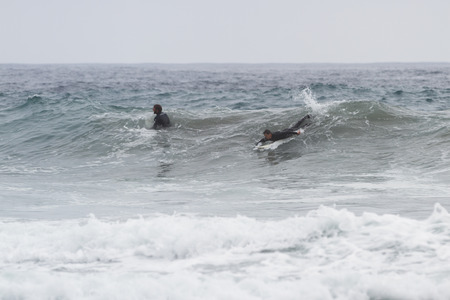 Pfeiffer Beach, California - May 01 : Male surfer in a full suit surfing on the cold waves of the California coast, May 01 2015 Pfeiffer beach, California.のeditorial素材