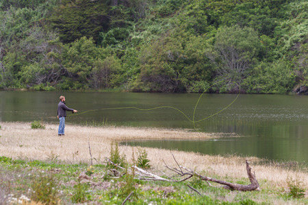 Trinidad, California - June 17 : young man fly flushing in a lagoon, June 17 2015 Trinidad, California.のeditorial素材