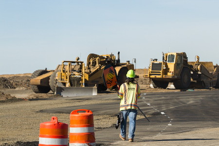 Worley, Idaho - September 23: Man in a safety vest directing traffic during construction, September 23 2015 in Worley, Idahoのeditorial素材
