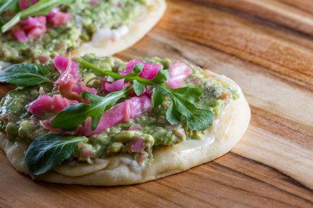 close up of a toasted slice of flat bread topped with a home made spread using avocado and fermented...