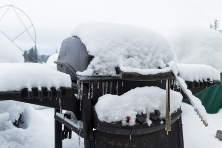 close up of a bar b que grill covered in snowの写真素材