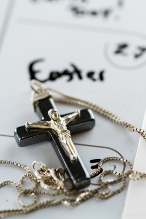 religious cross on a calendar on the date March 27 for a concept for Easter Sundayの写真素材
