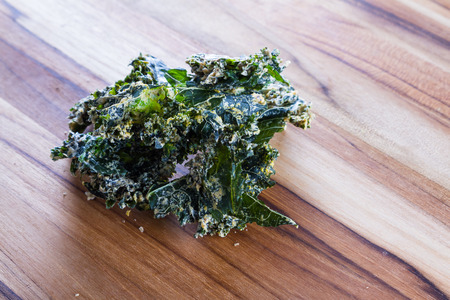 close up of a kale chip covered with melted parmesan cheese and spicesの写真素材