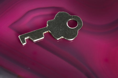 close up of an old key on a vivid polished slice of rock
