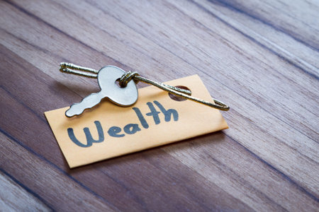 concept for a happy life using an old decorative key and a hand written tag attached by a golden...