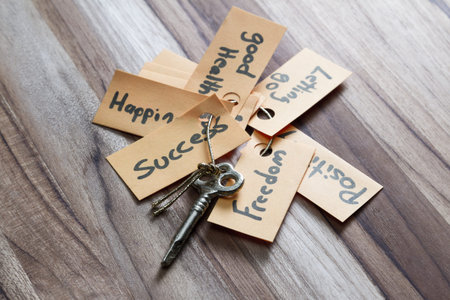 concept for a happy life using an old decorative key and a hand written tag attached by a golden...