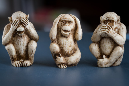 close up of hand small statues with the concept of see no evil, hear no evil and speak no evil.の写真素材