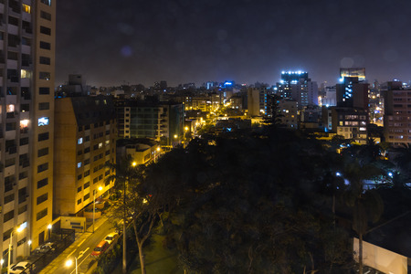 Lima Peru - May 09 : View of the city at night with a glare effect from the Dazzler Lima hotel room window, Lima. May 09 2016 Miraflores, Lima Peru.のeditorial素材