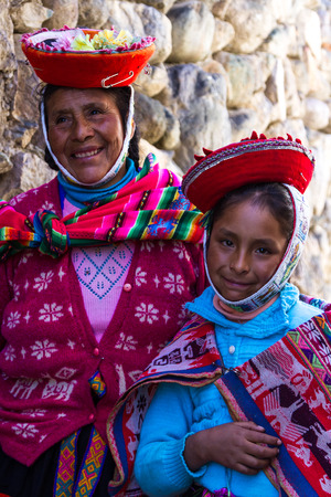 Ollantaytambo, Peru - May 16 : Grandmother and granddaughter posing for a picture with inca walls in the background. May 16 2016, Ollantaytambo Peru.のeditorial素材