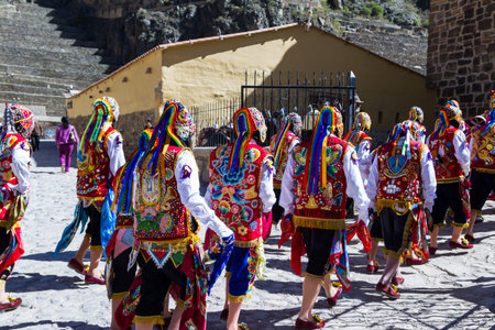 Ollantaytambo, Peru - May 16 : Religious celebration for Fiestas de Pentecostes with people wearing masks and colorful clothing on the streets of Ollantaytambo. May 16 2016, Ollantaytambo Peru.のeditorial素材