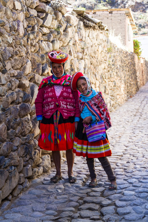 Ollantaytambo, Peru - May 16 : Grandmother and granddaughter posing for a picture with inca walls in the background. May 16 2016, Ollantaytambo Peru.のeditorial素材