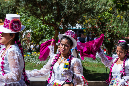 Ollantaytambo, Peru - May 16 : Religious celebration for Fiestas de Pentecostes with people wearing masks and colorful clothing on the streets of Ollantaytambo. May 16 2016, Ollantaytambo Peru.のeditorial素材