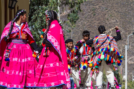 Ollantaytambo, Peru - May 16 : Religious celebration for Fiestas de Pentecostes with people wearing masks and colorful clothing on the streets of Ollantaytambo. May 16 2016, Ollantaytambo Peru.のeditorial素材