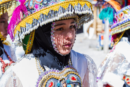 Ollantaytambo, Peru - May 16 : Religious celebration for Fiestas de Pentecostes with people wearing...