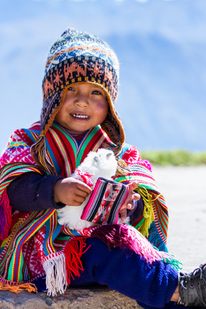 Huayllabamaba Peru -May 18 : young boy dressed in traditional native Peruvian clothing posing for a tip. May 18 2016, Huayllabamaba Peru.のeditorial素材