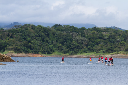 San Carlos, Costa Rica - May 27 : active people enjoying a tour of the lake using paddle boards. May 27 2016, San Carlos, Costa Rica.のeditorial素材