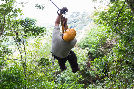 Monteverde, Costa Rica - May 29 : young adventurous man zip lining thru the cloud forest. May 29 2016, Monteverde, Costa Rica.のeditorial素材