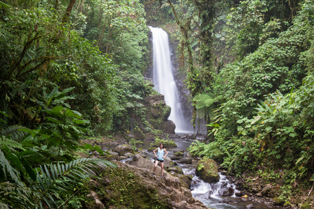 Alajuela, Costa Rica - May 02: families and friends enjoying the view of a beautiful waterfall in the rainforest. May 02 2016 Alajuela, Costa Rica.のeditorial素材