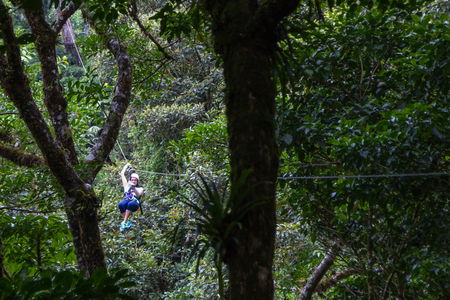 Monteverde, Costa Rica - May 29 : young adventurous woman zip lining thru the cloud forest. May 29 2016, Monteverde, Costa Rica.のeditorial素材