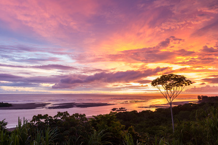 peaceful sunset scene with clouds above the pacific ocean in Uvita, Costa Ricaの写真素材