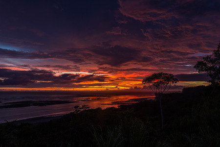 peaceful sunset scene with clouds above the pacific ocean in Uvita, Costa Ricaの写真素材