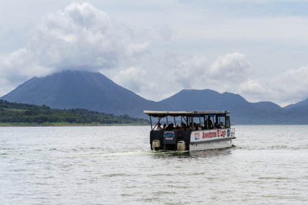 San Carlos, Costa Rica - May 27 : Adventure tour boat in Lake Arenal with the volcano in the background. May 27 2016, San Carlos, Costa Rica.のeditorial素材