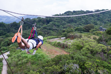Monteverde, Costa Rica - May 29 : young adventurous man zip lining thru the cloud forest. May 29...