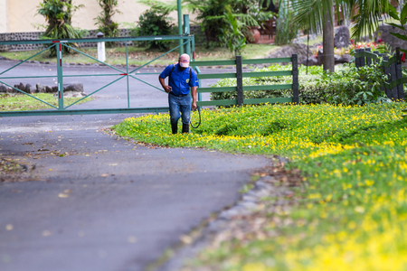San Carlos, Costa Rica - May 25 : Local workers spraying pesticides and herbicides to maintain a healthy eco friendly resort. May 25 2016, San Carlos, Costa Rica.のeditorial素材