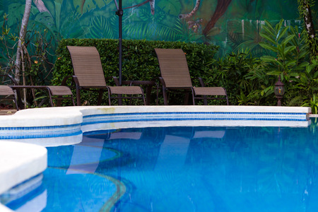 Close up view of a lounge area near relaxing swimming pool in the Costa Rican rainforestのeditorial素材