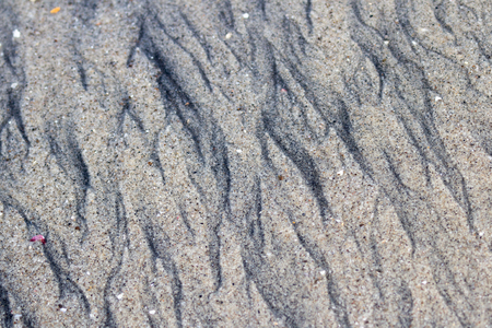 close up of a beach sand with different layers of white and black sand exposedの写真素材
