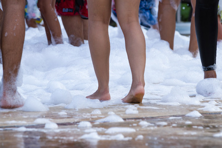 peoples feet in a foam party as hotel entertainment in Panamaの写真素材