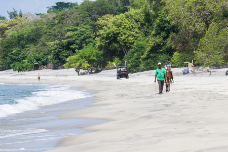 Santa Clara, Panama- June 12: young boy on a horse riding along the beach in Panama. June 12 2016, Santa Clara, Panama.のeditorial素材