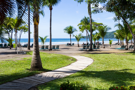 Tambor, Costa Rica - June 25: Tranquil beach scene with people enjoying a relaxing morning. June 25 2016, Tambor, Costa Rica.のeditorial素材