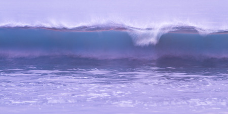 sunset glow used for lighting with a slow shutter speed on moving waves in the pacific coast of Costa Ricaの写真素材