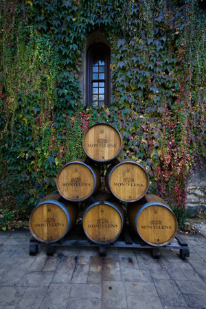 Calistoga, California - November 08: Wine barrels stacked in front of Chateau Montelena with a green...