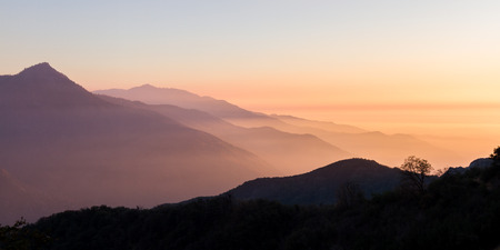 beautiful sunset with a lawyer of smoke in the air from prescribed burns near the Sequoia National Parkの写真素材