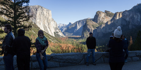 Yosemite NP, California - November 17: Tourists posing for a photograph with The Yosemite Valley. November 17 2016, Yosemite NP, California.のeditorial素材