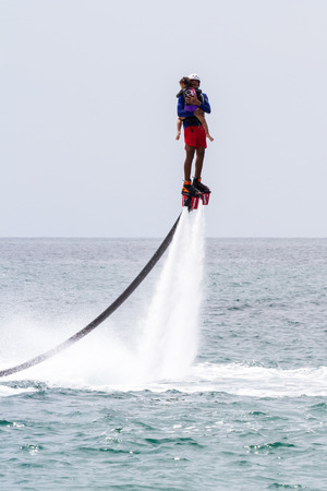 Santa Clara, Panama- June 12: Local people enjoying a thrilling experience on a flyboard in the Pacific ocean. June 12 2016, Santa Clara, Panama.のeditorial素材