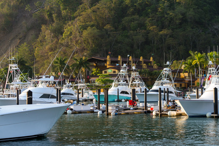 Herradura, Costa Rica - February 25: Beautiful fishing boats docked at Los Suenos Marina. Herradura, Costa Rica - February 25のeditorial素材