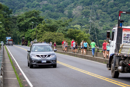 Puntarenas, Costa Rica - July 18 : Tourists walking on the Tarcoles bridge, a famous crocodile viewing place. July 18 2017, Puntarenas, Costa Rica.のeditorial素材